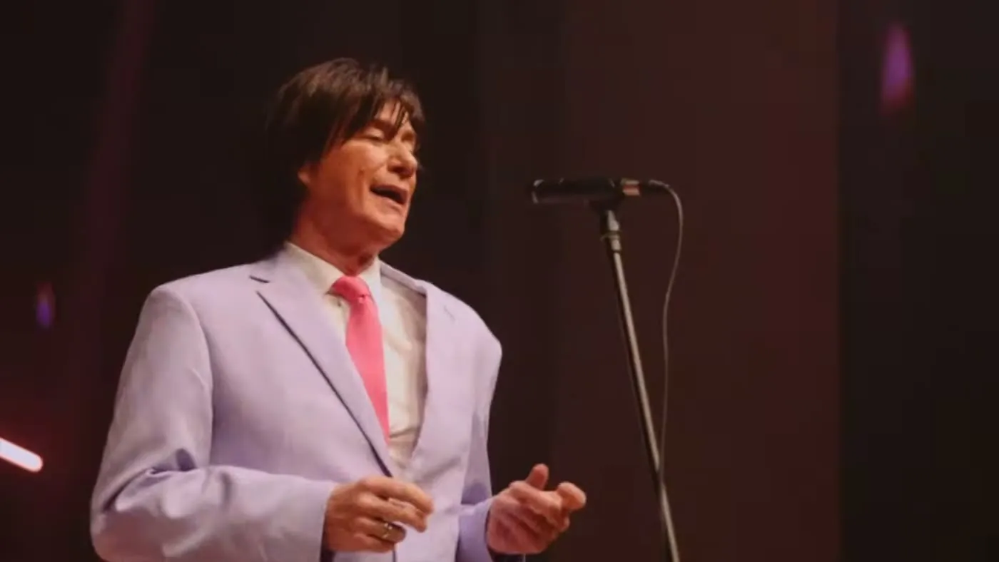 Sam Stevens in a lilac suit with a pink tie